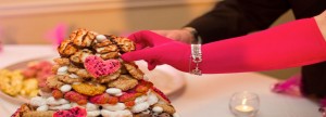 Hot pink gloved bride reaches for cookie (you don't have to be Italian for cookie cakes at your wedding!)