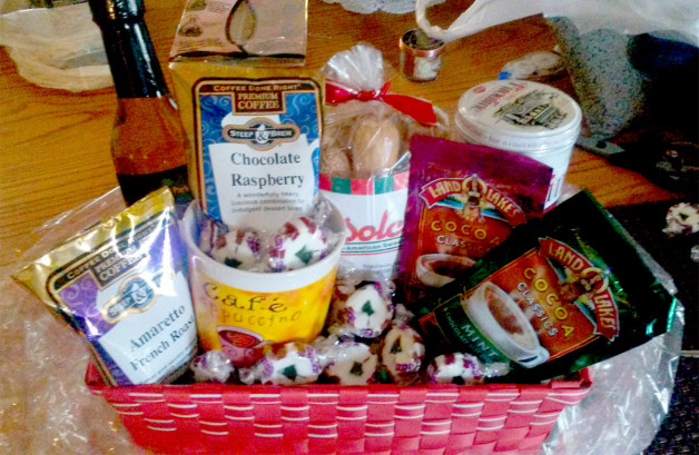 Basket full of items that would be great for a coffee break - coffee, flavor, biscotti, candies